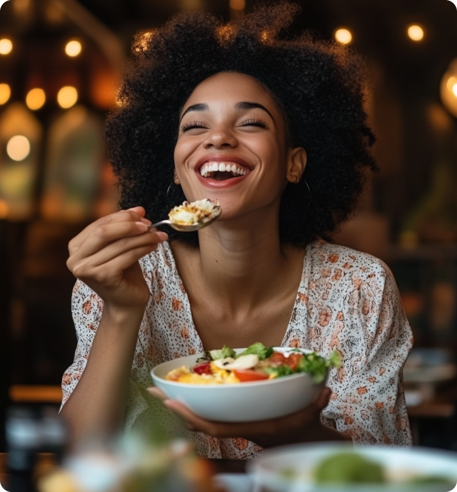woman eating salad and smiling