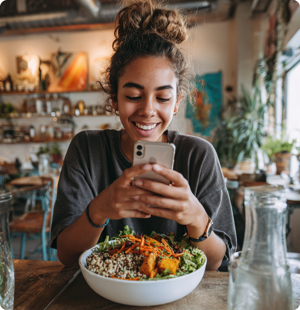woman eating salad and smiling